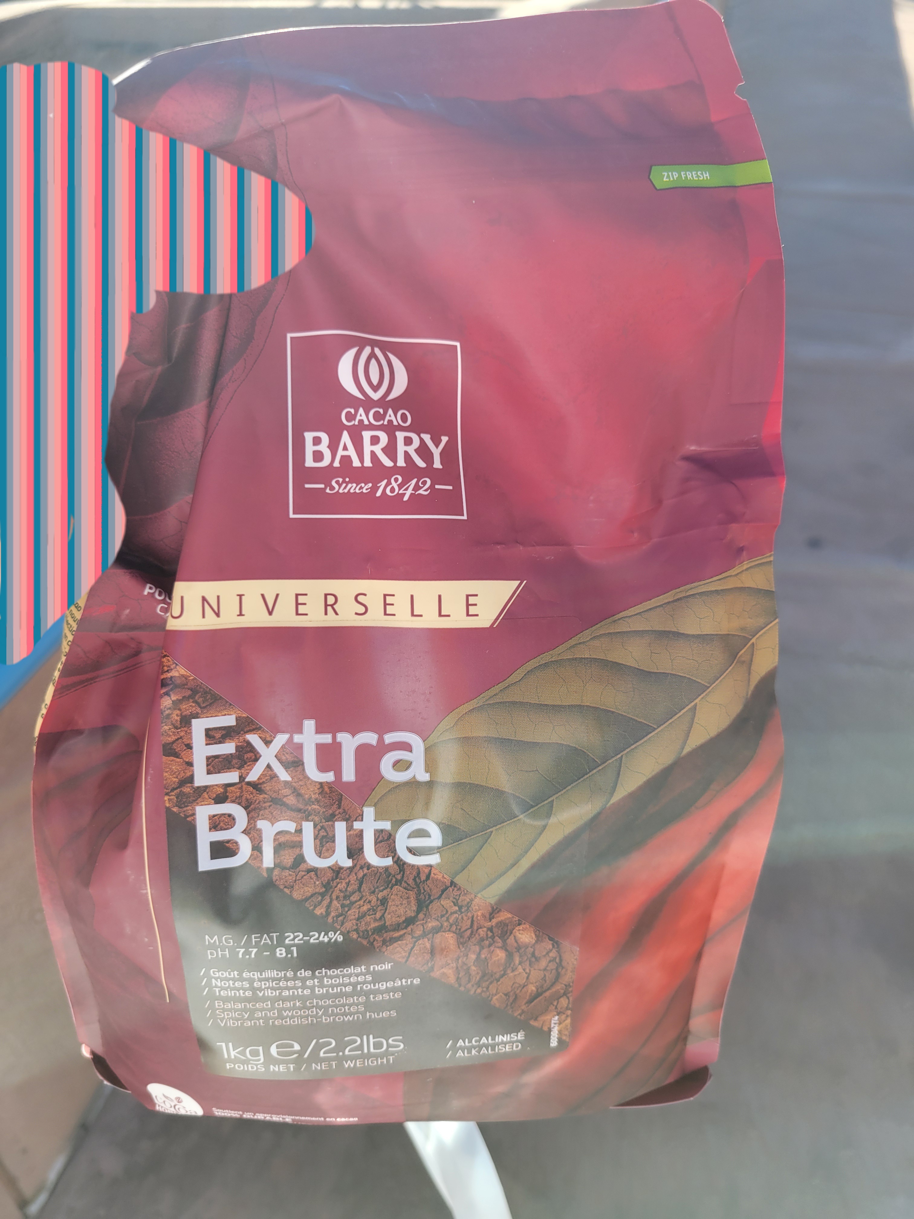 Hand holds big bag of cocoa powder.